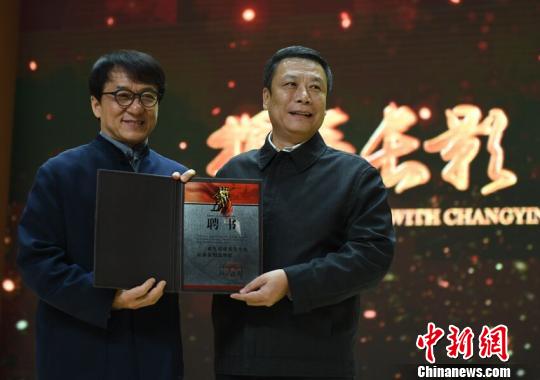 長(zhǎng)影集團(tuán)董事長(zhǎng)趙彪(右)為成龍頒發(fā)了總導(dǎo)演聘書(shū) 張瑤 攝